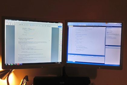 Dual screen monitors displaying C# code