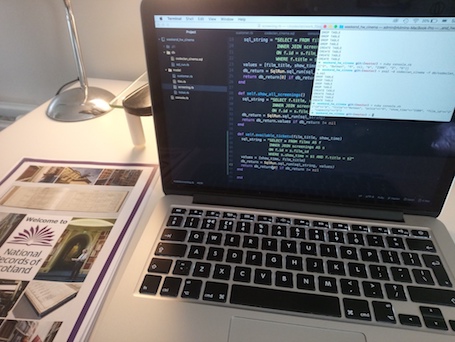 National Records of Scotland leaflet beside Macbook displaying code